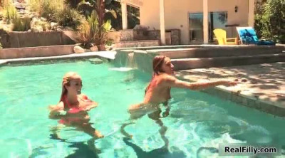 One cute brunette and her steamy blonde friend trying some lesbian sex in the pool